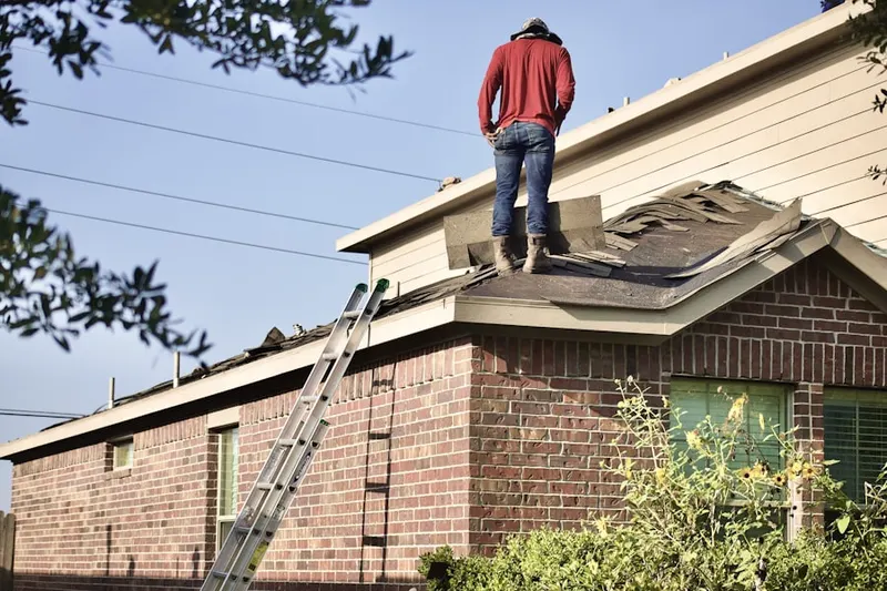 Professional roofer working on a residential roof in Moriches